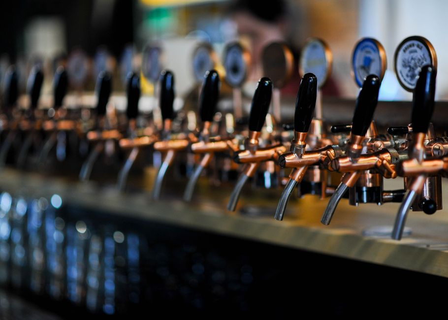 Beer taps lined up at a bar